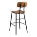 A Lancaster Table & Seating black barstool with wood seat and backrest.