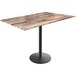 A Holland Bar Stool EuroSlim bar height table with a rustic wood top and black round base.