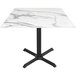 A white marble Holland Bar Stool EuroSlim table with black base.