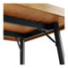 A Lancaster Table & Seating butcher block table with black metal legs.