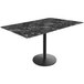 A Holland Bar Stool black marble table top on a round metal base.