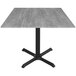 A Holland Bar Stool EuroSlim square table with a Greystone top and black cross base.