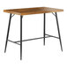 A Lancaster Table & Seating butcher block table with black legs.