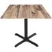 A Holland Bar Stool rustic wood square table with a cross base.