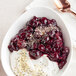 A bowl of yogurt with IQF organic pitted dark sweet cherries.
