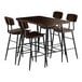 A Lancaster Table & Seating butcher block bar height table with 4 wooden barstools.