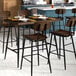 A Lancaster Table & Seating Mid-Century rectangular bar height table with an espresso finish and 4 barstools.