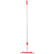 A Unger Restroom Complete Mop with a red and white mop with a long white pole and a red top.