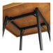 A Lancaster Table & Seating wood table with a metal base and black legs.