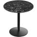 A Holland Bar Stool EuroSlim round black marble table with a black round base.