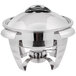 A Vollrath stainless steel round chafer with a lid on a table.