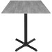 A Holland Bar Stool EuroSlim bar height table with a black base and grey top.