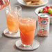 A person pouring Ruby Kist grapefruit juice into a glass.