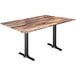 A Holland Bar Stool EuroSlim table with a rustic wood top and black end column base.