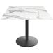 A white marble Holland Bar Stool table with a round black base.