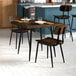 A Lancaster Table & Seating Mid-Century espresso butcher block table with chairs set in a kitchen.