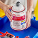 A person holding a white container with a red label of SC Johnson Professional TruFill Heavy-Duty Neutral Floor Cleaner.