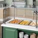 A ServIt drop-in hot food well on a counter with food in it.