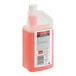 A bottle of SC Johnson Professional Heavy-Duty Neutral Floor Cleaner with a red cap filled with pink liquid.