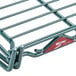 A Metro metal grid shelf in green.