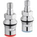 A close-up of a Eagle Group faucet spindle kit with two stainless steel pieces and red and blue caps.