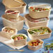 A variety of Solia Lingot bamboo fiber containers with food in them.