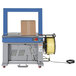 A Vestil high speed automatic strapping machine with a box on it.