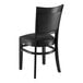 A Lancaster Table & Seating Sofia black wood chair with black cushion.