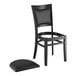 A Lancaster Table & Seating black wood chair with black vinyl cushion.