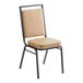 A Lancaster Table & Seating banquet chair with a tan vinyl seat and a black frame.