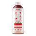 A white plastic bottle of Smartfruit Summer Strawberry Puree with red and white labels. The bottle is filled with red liquid.