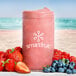 A close-up of a pink Smartfruit Blooming Berry smoothie with strawberries and blueberries.