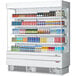 A white Turbo Air narrow depth vertical air curtain display case filled with drinks and beverages.