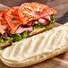 A sandwich with tomatoes and lettuce on white bread.