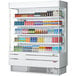 A Turbo Air white narrow depth vertical air curtain display case filled with drinks and beverages.