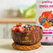 A bowl of fruit next to a bottle of Smartfruit Superfruit All-Stars puree.