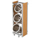 A Cal-Mil bamboo rack with 3 metal cylinders with holes in them.