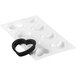 A Silikomart heart-shaped silicone mold with black rubber rings.