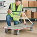 A man folding a Lavex aluminum platform truck.