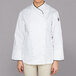 A woman wearing a white Chef Revival executive long sleeve coat with black piping.