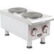 An APW Wyott stainless steel dual solid burner countertop electric range on a counter.