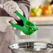 A person using a Choice aluminum lime squeezer to juice a lime.