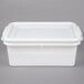 A white plastic Vollrath perforated drain box with a lid.