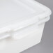 A white plastic Vollrath perforated drain box with a lid.