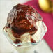 A close up of a scoop of Oringer black raspberry dessert topping on ice cream.