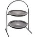 A Rosseto two tier round display stand with black glass platters on it.