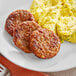 A plate with a MorningStar Farms vegetarian sausage patty and eggs.