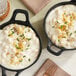 Two black pans filled with Stouffer's White Cheddar Macaroni and Cheese.