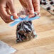 A person's hands wrapping chocolate candies in an LK Packaging candy bag.