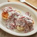 A plate of Stouffer's creamed chipped beef with a biscuit and a fork.